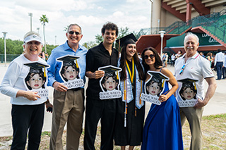 Family poses outside USF commencement