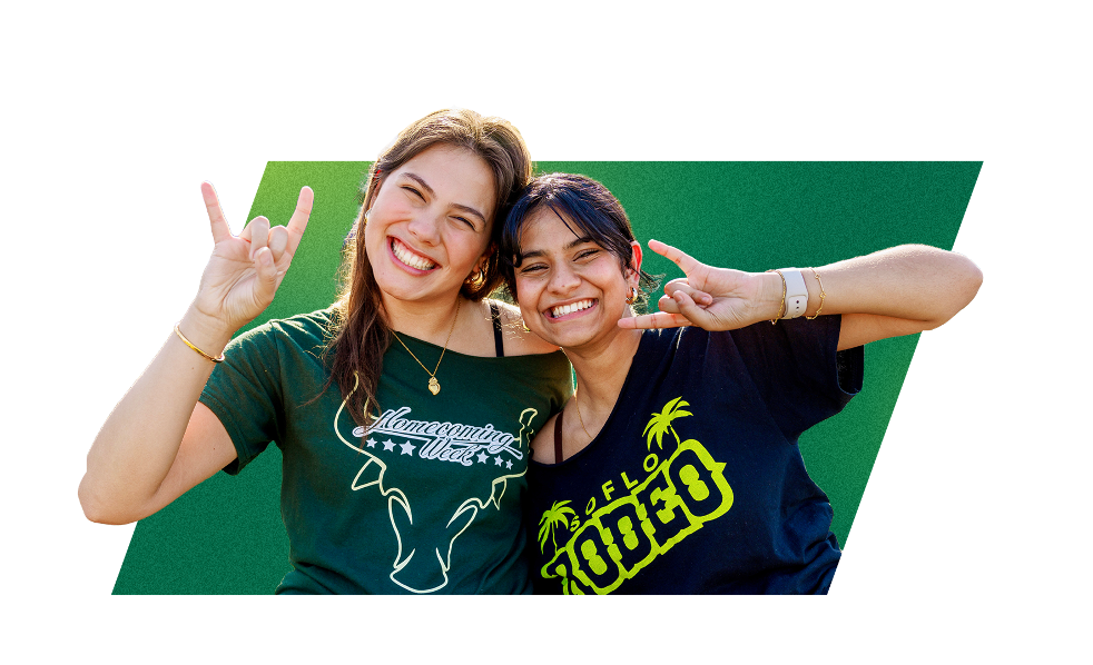 Two USF students holding up the Go Bulls hand symbol.